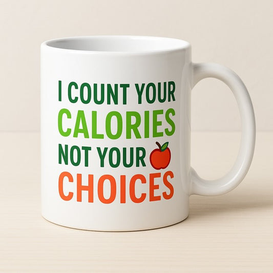 Λευκή κεραμική κούπα με τη φράση "I count your calories, not your choices" σε πράσινο και πορτοκαλί, με σχέδιο μήλου, ιδανική για διαιτολόγους και διατροφολόγους - The Gift Box thegiftbox.gr